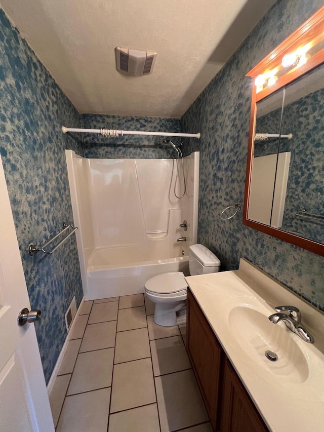 full bathroom featuring tile patterned floors, shower / bathtub combination, vanity, a textured ceiling, and toilet