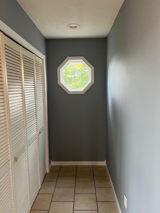 hallway with light tile patterned floors