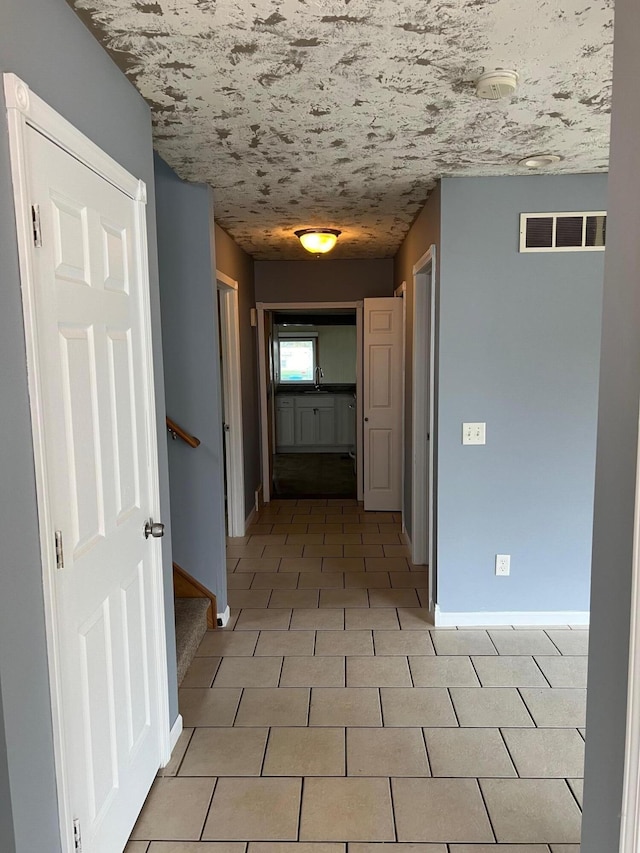 hall with light tile patterned flooring