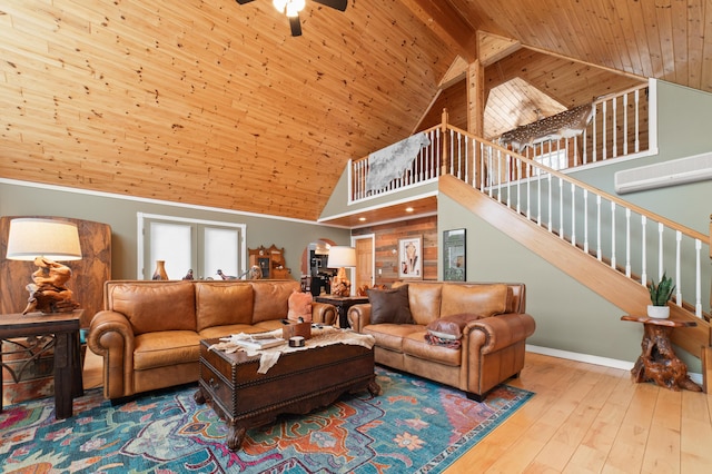 living room with wooden ceiling, a wall unit AC, light wood-style flooring, a ceiling fan, and stairway