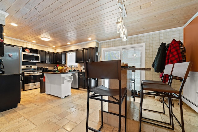 kitchen with ornamental molding, appliances with stainless steel finishes, pendant lighting, and wooden ceiling