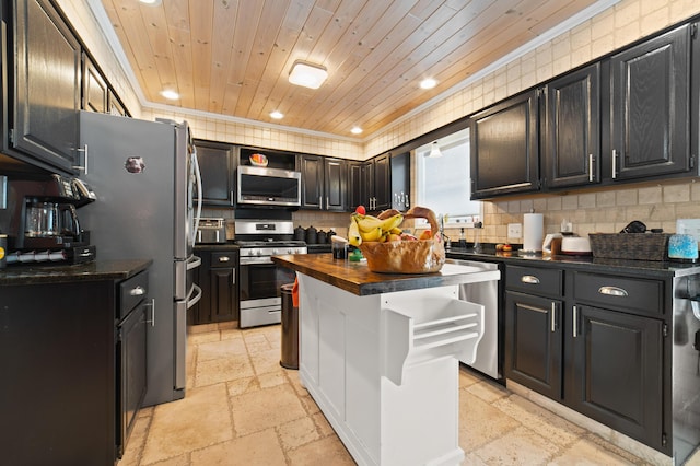 kitchen with stone tile floors, decorative backsplash, wood ceiling, stainless steel appliances, and wooden counters