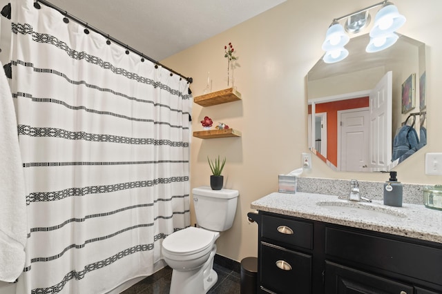 bathroom featuring toilet, a shower with curtain, vanity, and tile patterned floors