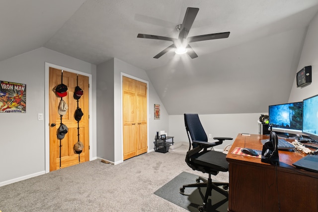 office space with carpet, baseboards, and vaulted ceiling