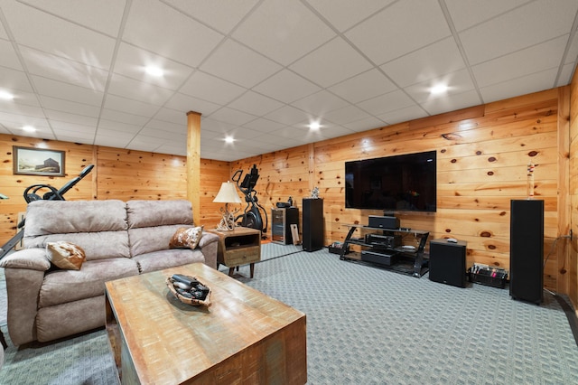 living area featuring carpet flooring and wood walls