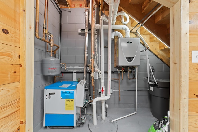 utility room featuring water heater and a heating unit