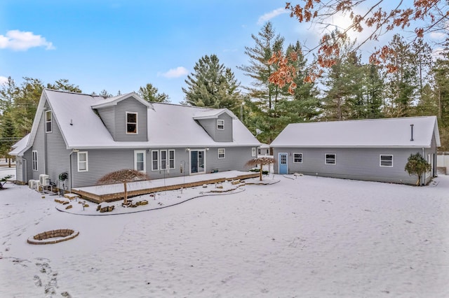 view of snow covered back of property