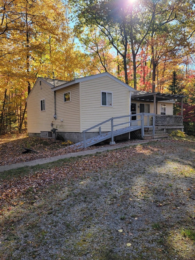 view of home's exterior with a wooden deck