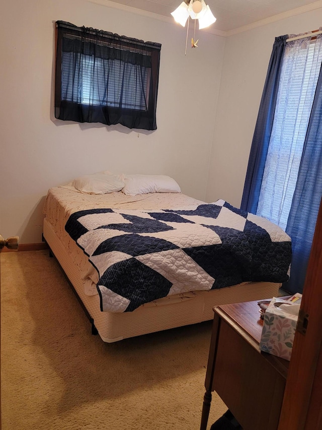 bedroom with carpet floors and ornamental molding