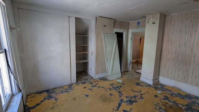 unfurnished bedroom with wooden walls