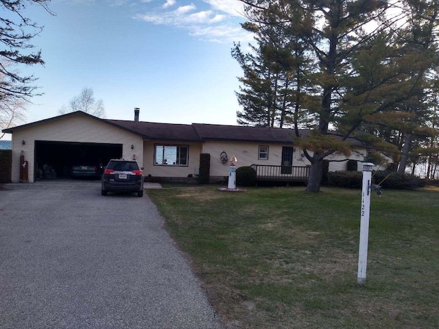 single story home with a front yard and a garage