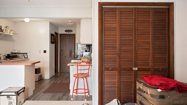 kitchen featuring hardwood / wood-style flooring and white cabinetry