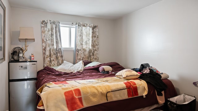 bedroom featuring fridge