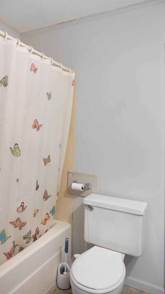 bathroom featuring shower / tub combo and toilet