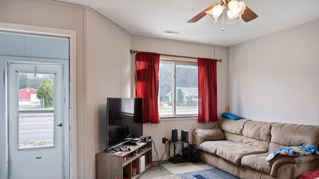 living room with a wealth of natural light and ceiling fan