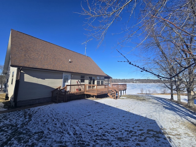 snow covered property with a deck