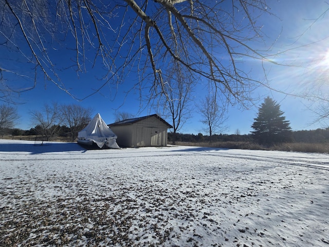 snowy yard with an outbuilding