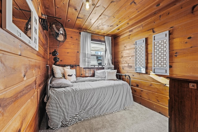 carpeted bedroom featuring wooden ceiling and wood walls