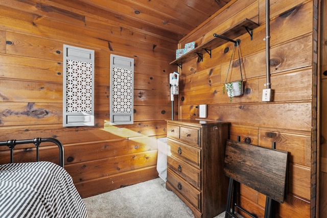 carpeted bedroom with wooden ceiling and wooden walls