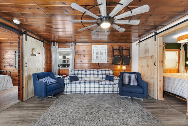 sitting room with wooden ceiling, a barn door, and hardwood / wood-style floors