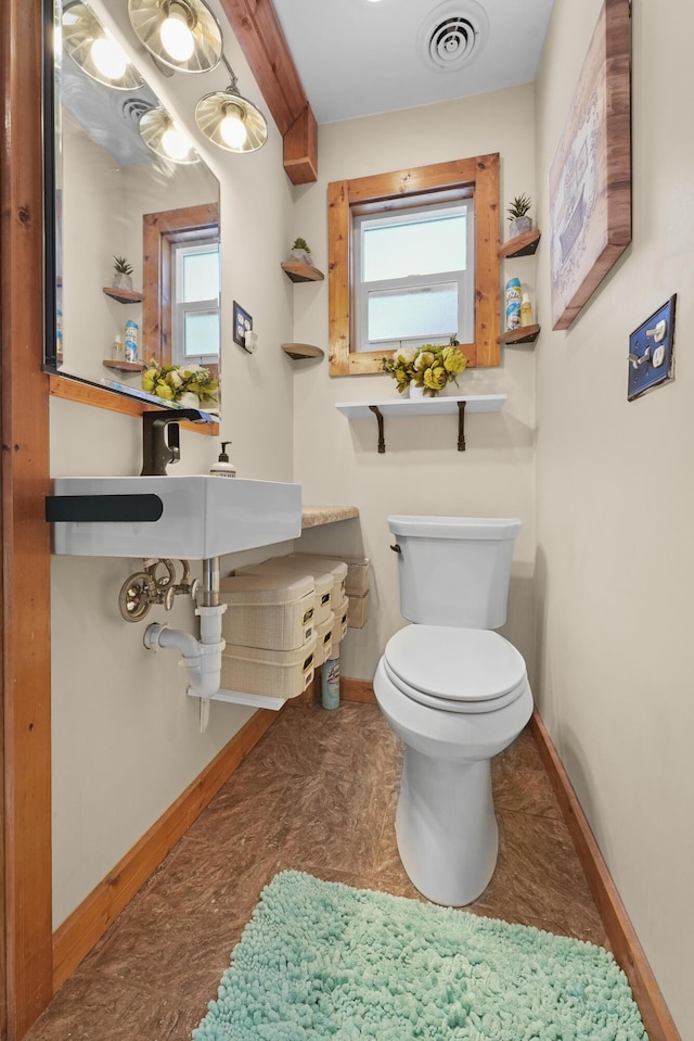 bathroom featuring toilet and beam ceiling