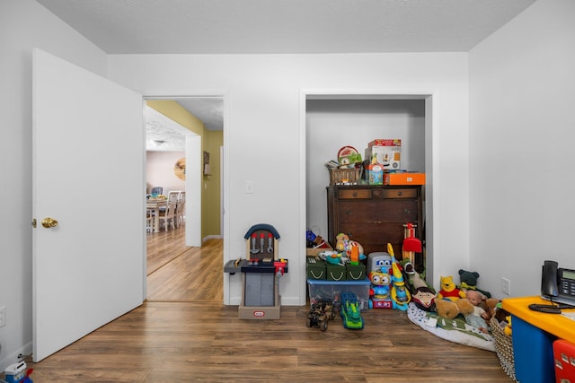 playroom with dark hardwood / wood-style flooring