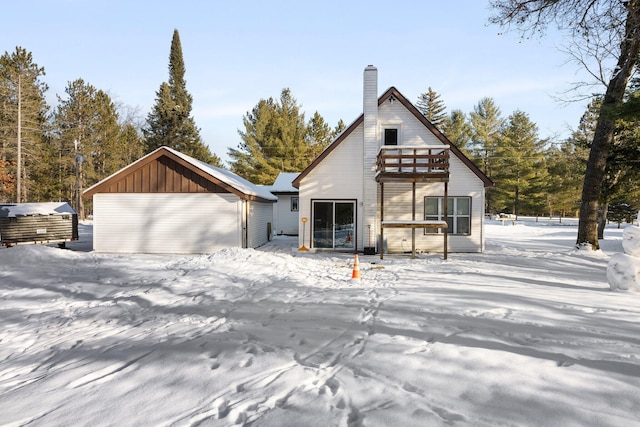 view of front of home featuring a garage and an outbuilding