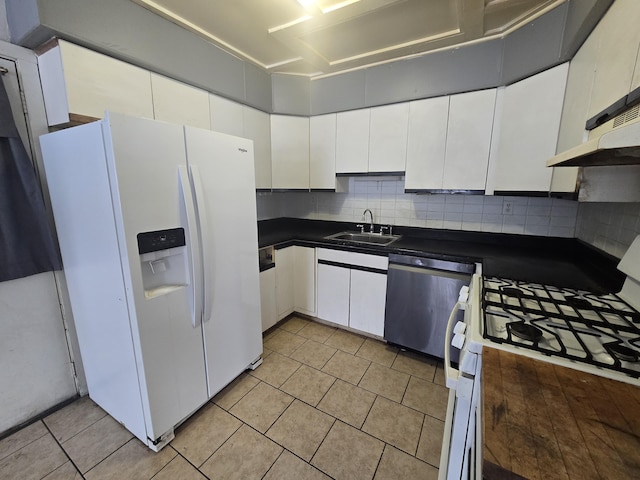 kitchen with white appliances, light tile patterned floors, decorative backsplash, white cabinets, and sink