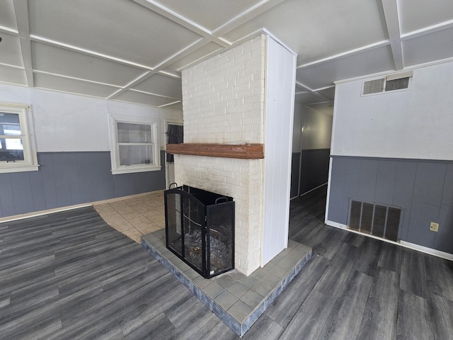 living room with coffered ceiling, a fireplace, and dark hardwood / wood-style floors