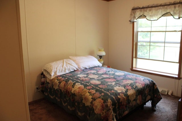 bedroom featuring dark colored carpet