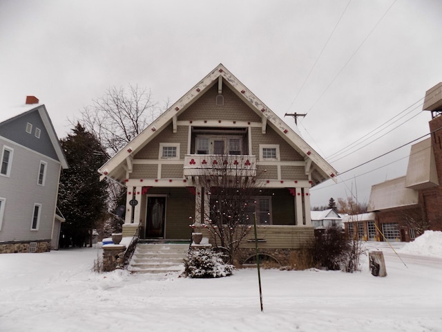 view of front of house featuring covered porch and a balcony