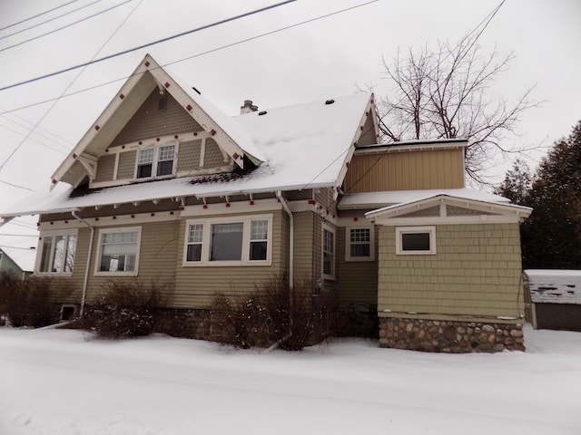 view of snow covered rear of property