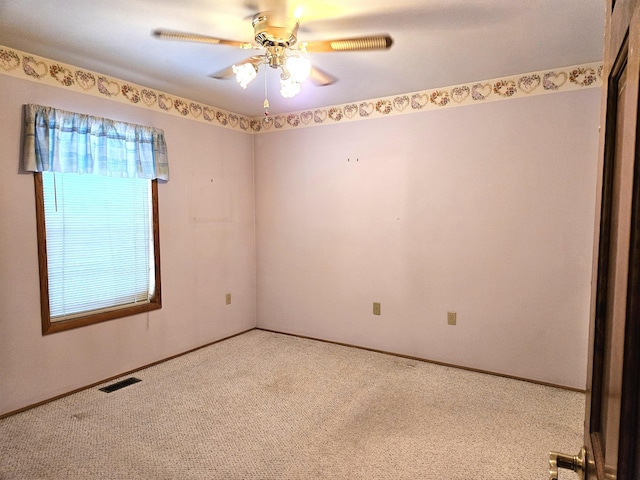 carpeted spare room with ceiling fan