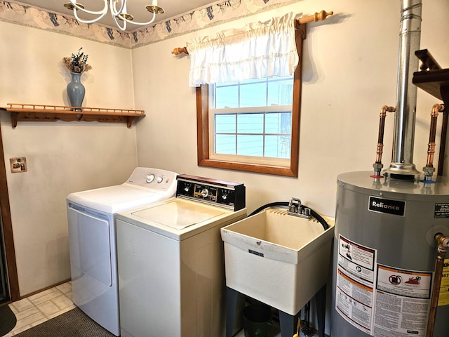 clothes washing area with water heater, sink, and washing machine and clothes dryer