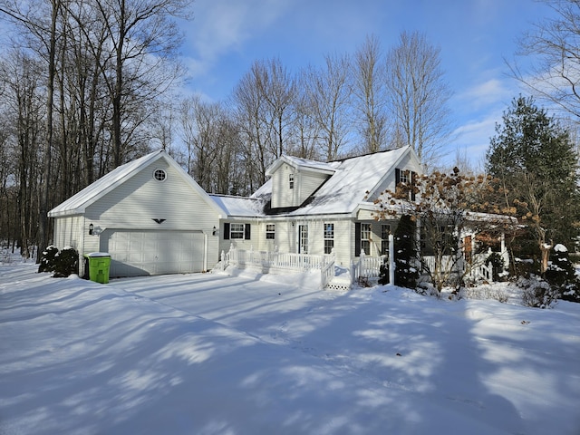 view of snow covered exterior with a garage