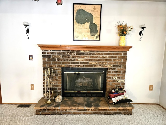 details featuring a brick fireplace and carpet flooring