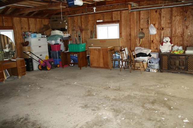 garage with wood walls and a garage door opener