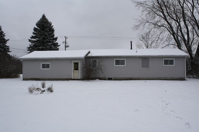 view of snow covered rear of property