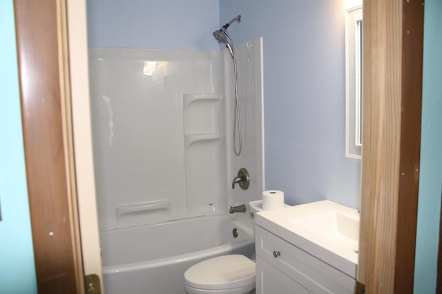 full bathroom with bathing tub / shower combination, vanity, and toilet