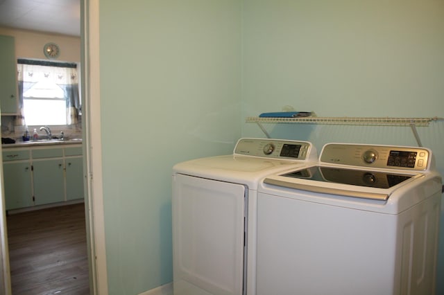 clothes washing area featuring independent washer and dryer and sink