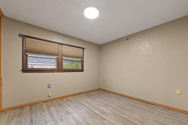 unfurnished room featuring light hardwood / wood-style floors