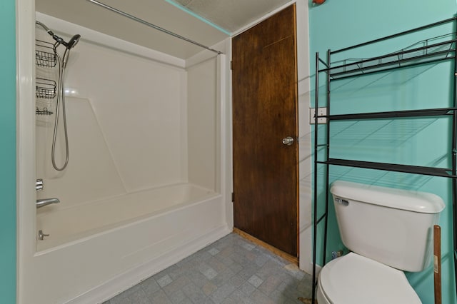 bathroom featuring shower / washtub combination and toilet