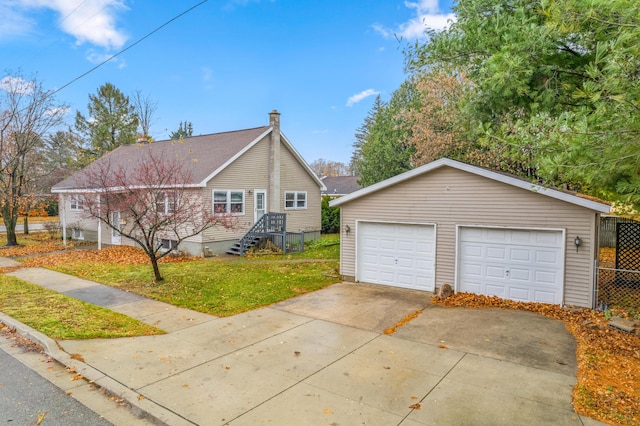 view of property exterior featuring a garage, an outdoor structure, and a lawn