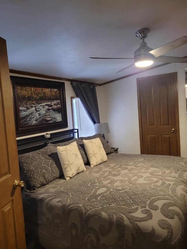 bedroom with ceiling fan and ornamental molding