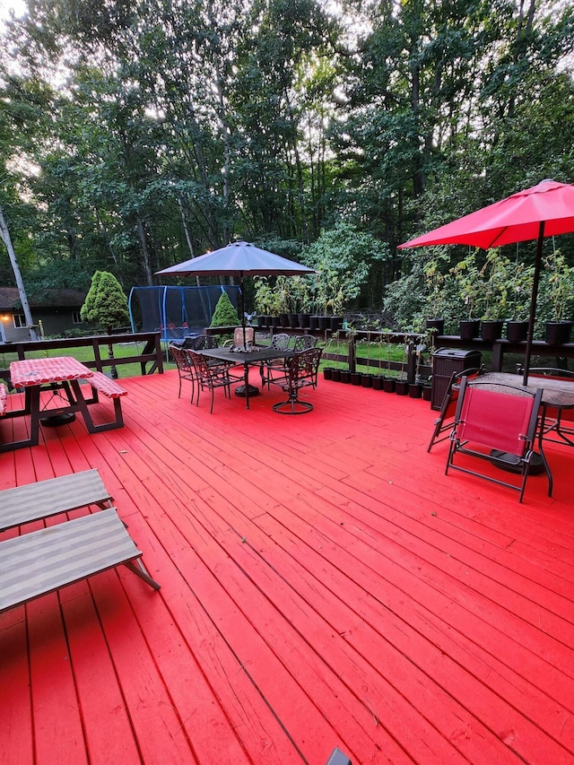 wooden deck with a trampoline