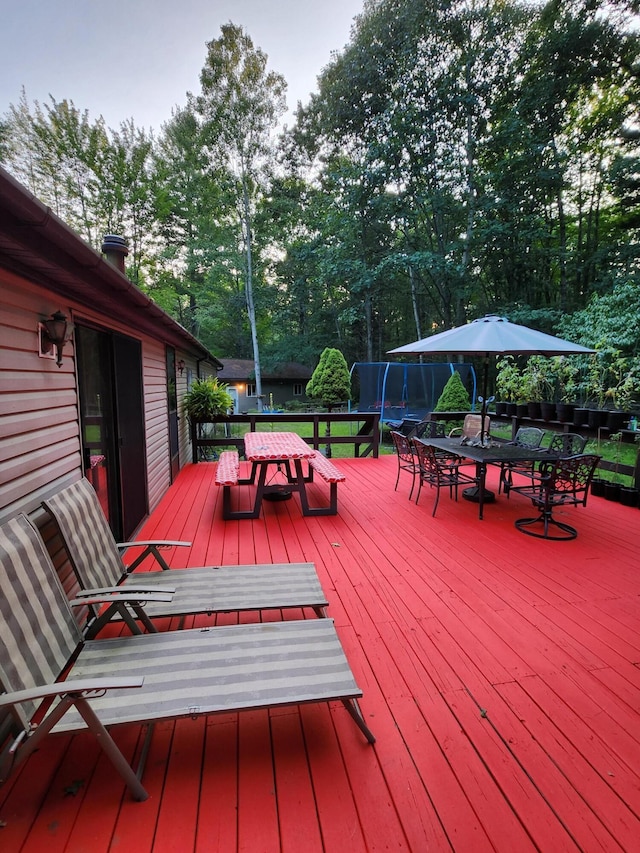 wooden deck with a trampoline