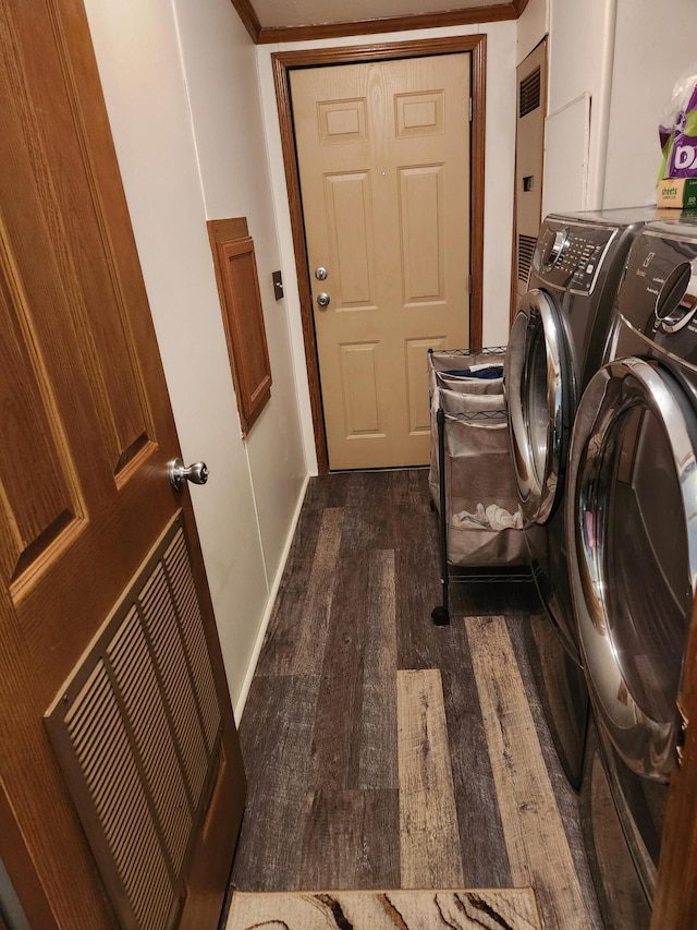 washroom with washing machine and clothes dryer, dark hardwood / wood-style flooring, and electric panel