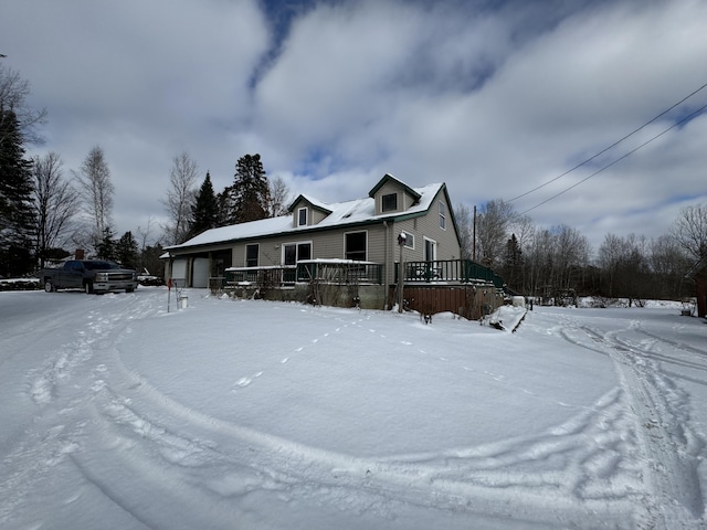 view of front of property featuring a garage and a deck