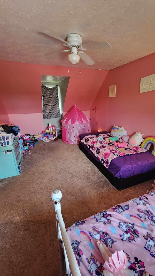 carpeted bedroom featuring lofted ceiling, a textured ceiling, and ceiling fan