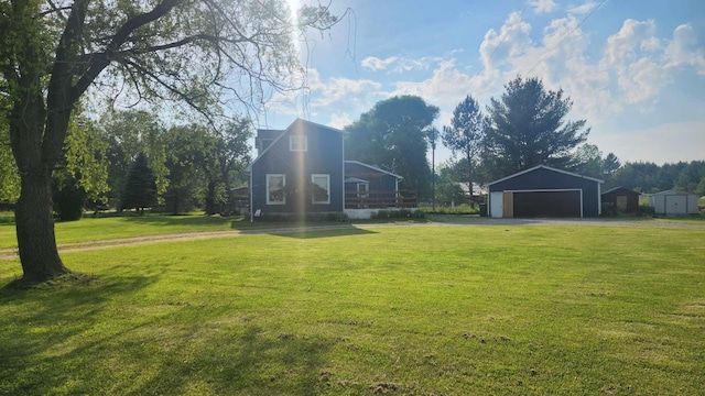 view of yard with a garage and an outdoor structure